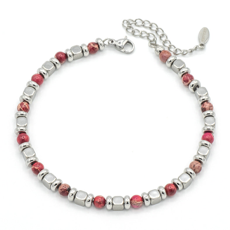 Bracciale in acciaio e sfere in pietra rossa